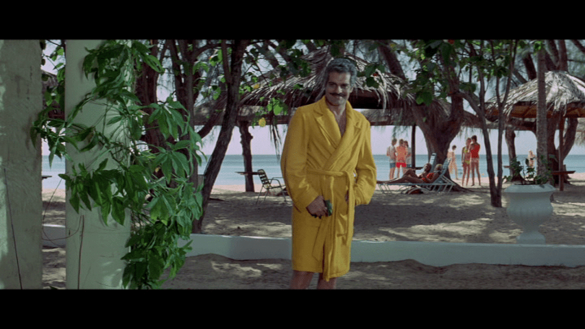 Screengrab from The Tamarind Seed showing Omar Sharif in a bright yellow robe