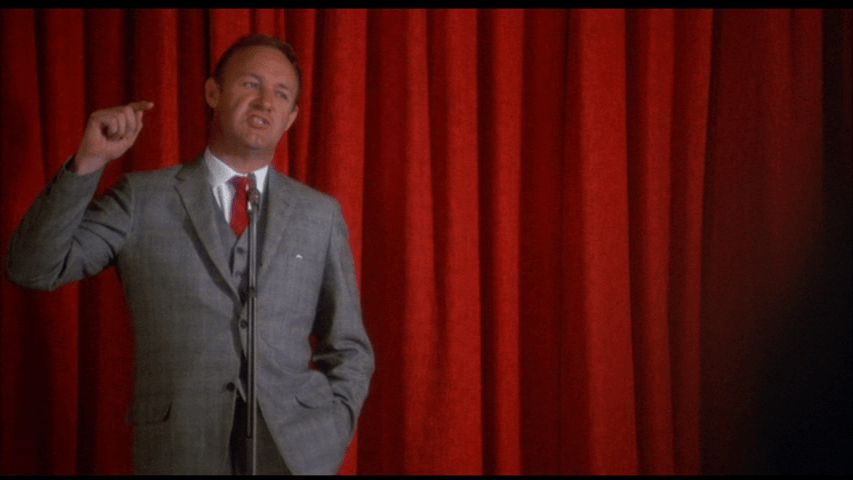 Screengrab from Downhill Racer showing Gene Hackman's character trying to raise funds for the U.S. national ski team.