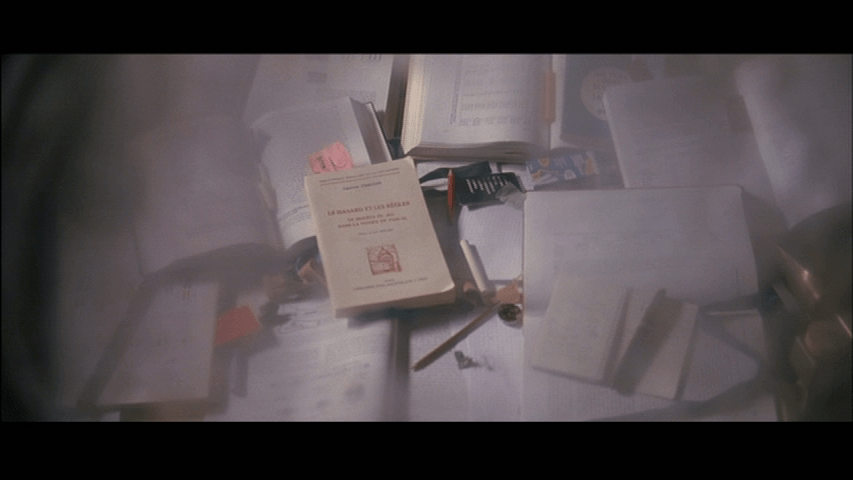 Screengrab from A Christmas Tale showing a pile of books