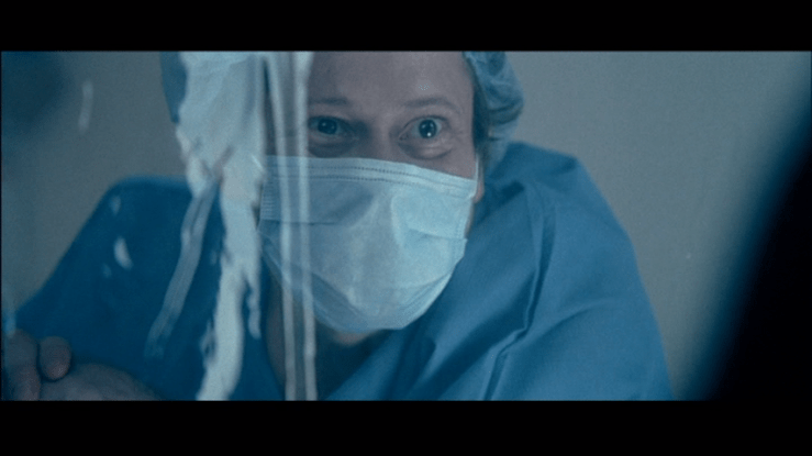 Screengrab from A Christmas Tale showing Henri wearing a surgical mask