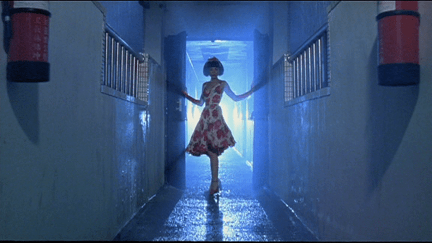 Screengrab from the "Tiger Lady" musical number from The Hole showing The Woman Downstairs bathed in light, as though powered by some kind of supernatural force