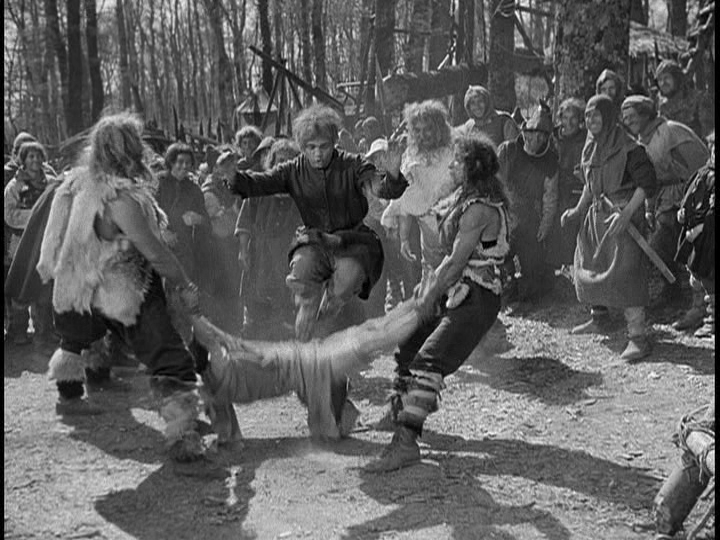 Screengrab from The Flowers of St. Francis showing the tyrant Nicolaio's men using Brother Juniper as a jump rope