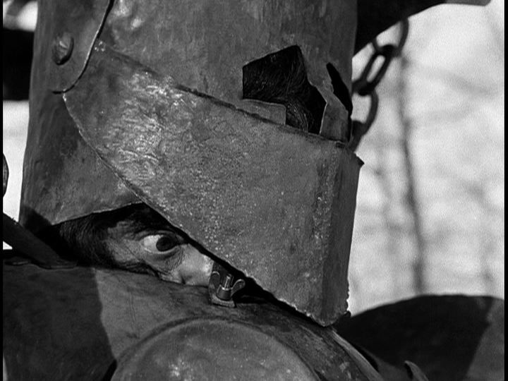 Screengrab from The Flowers of St. Francis showing Nicolaio struggling to see through is over-sized armor