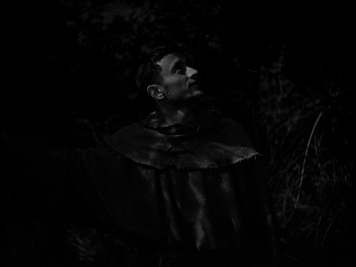 Screengrab from The Flowers of St. Francis showing Francis looking up at the sky and smiling