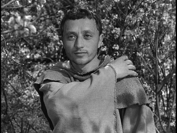 Screengrab from The Flowers of St. Francis showing Francis reaching for the bird on his shoulder