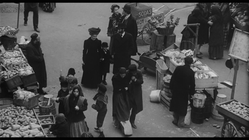 Screengrab from Hester Street showing Gitl and Bernstein walking down the street talking