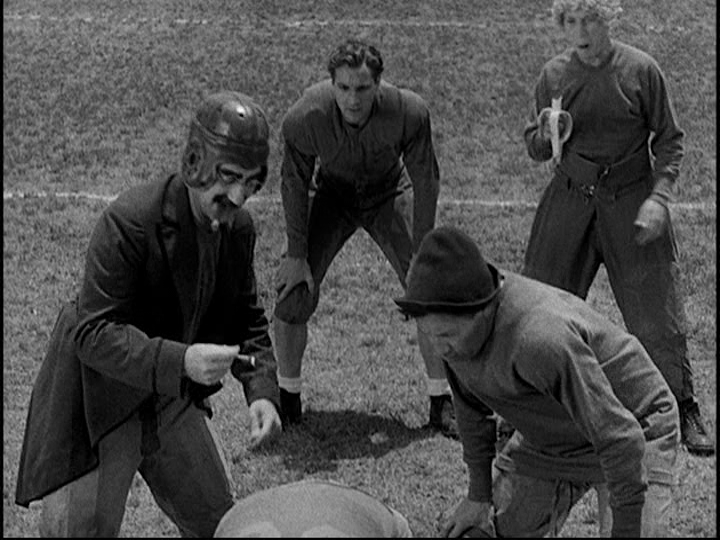 Sceengrab from Horse Feathers showing the characters played by the Marx Brothers getting ready to snap the ball