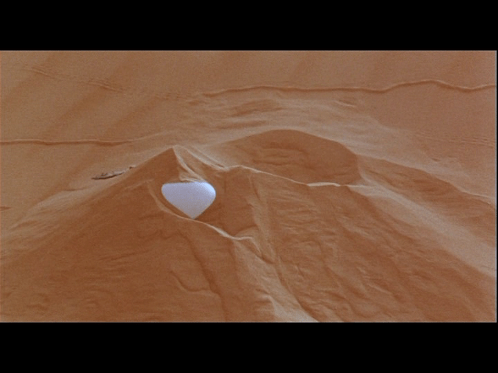 Screengrab from Yeelen showing a single ostrich egg in the sand
