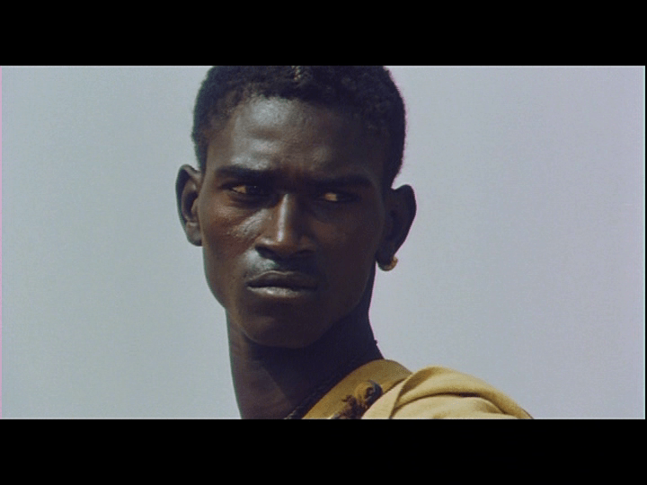 Screengrab from Yeelen showing Nianankoro looking on while his captors all whet their thirst.