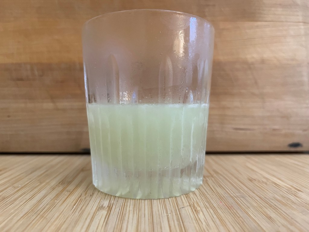 The Grinch in a rocks glass