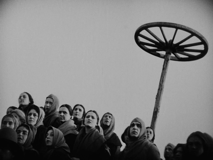 Shot of onlookers at the bottom of the frame with a Catherine Wheel behind them