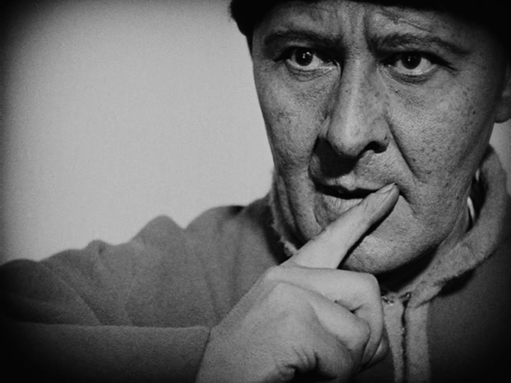 Shot of a judge cautioning Joan to be careful by placing a finger to his lips