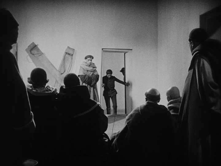 Shot of Joan entering a doorway which isn't perfectly rectangular