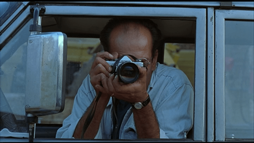 Medium close-up of Behzad taking a picture