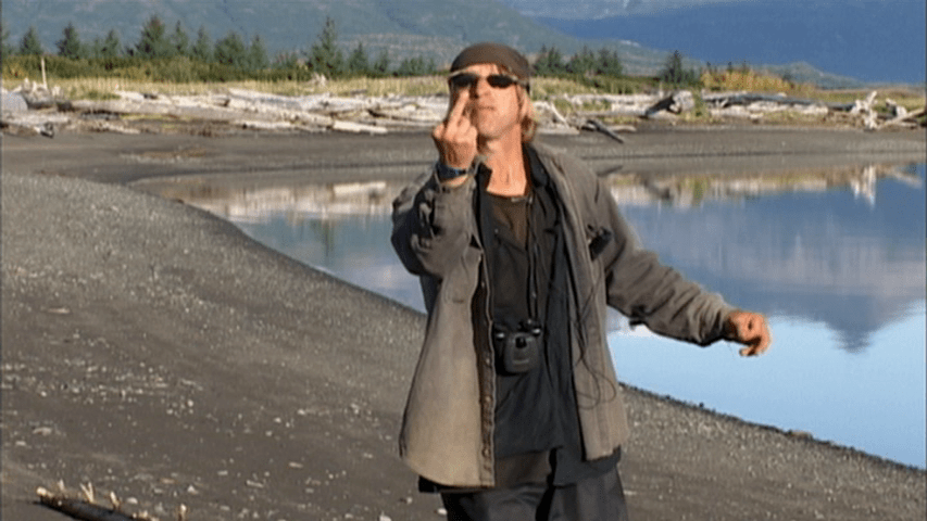 Medium shot of an angry Timothy Treadwell giving the finger to his camera