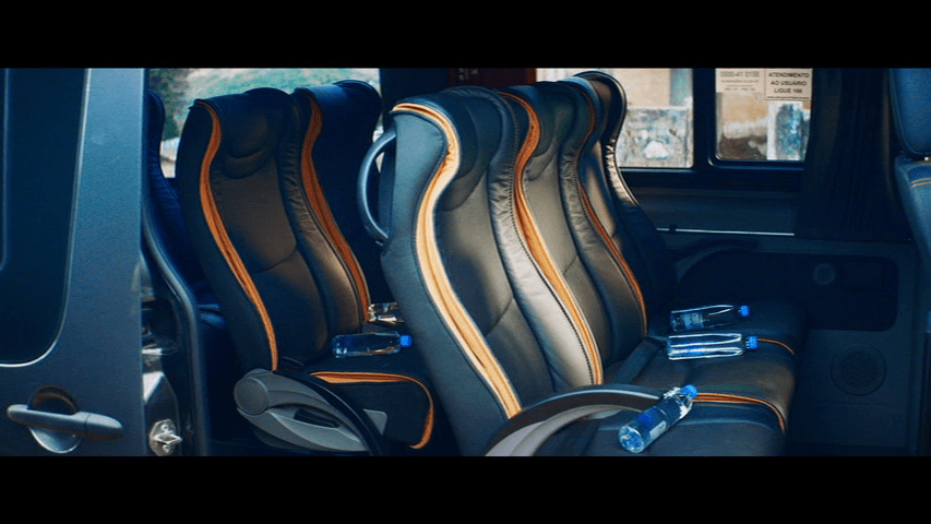 Close up of an empty van with bottles of spring water on each seat