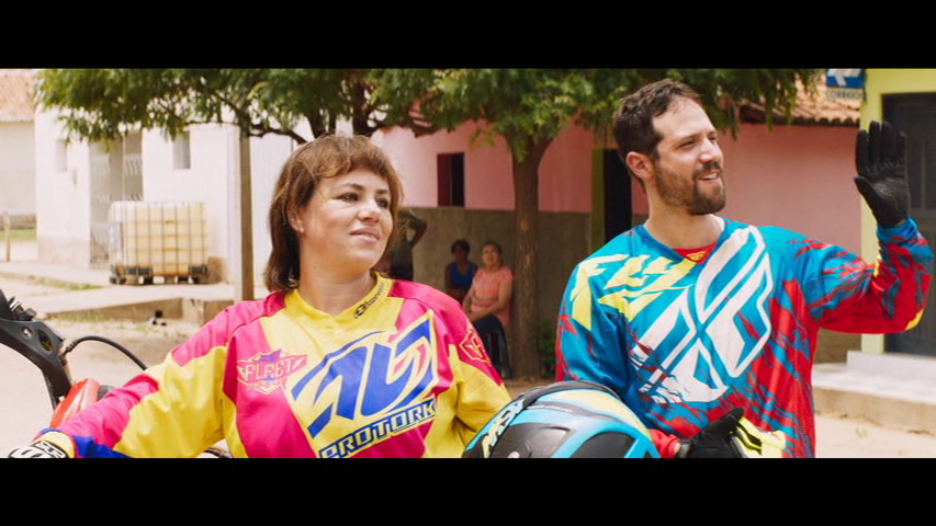 Medium shot of two bikers from the south in garish outfits