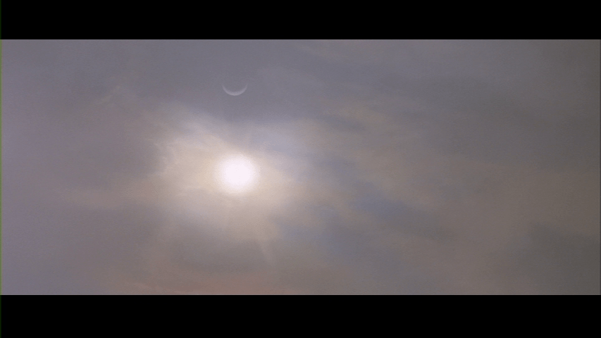 Crescent moon over the sun