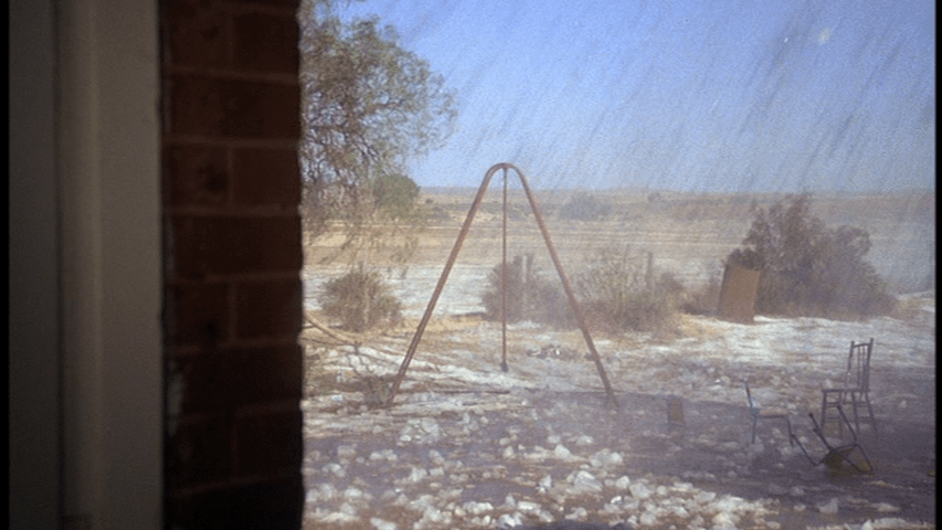 POV shot of a playground covered by huge pieces of hail