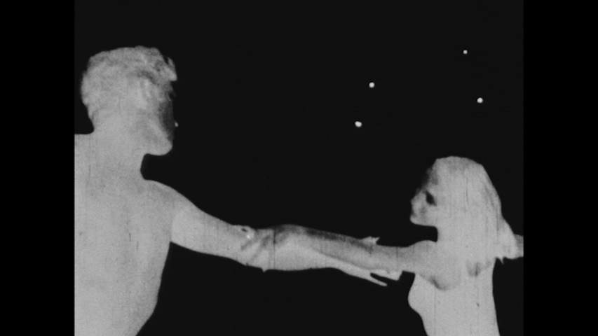 A male and female dancer with arms clasped