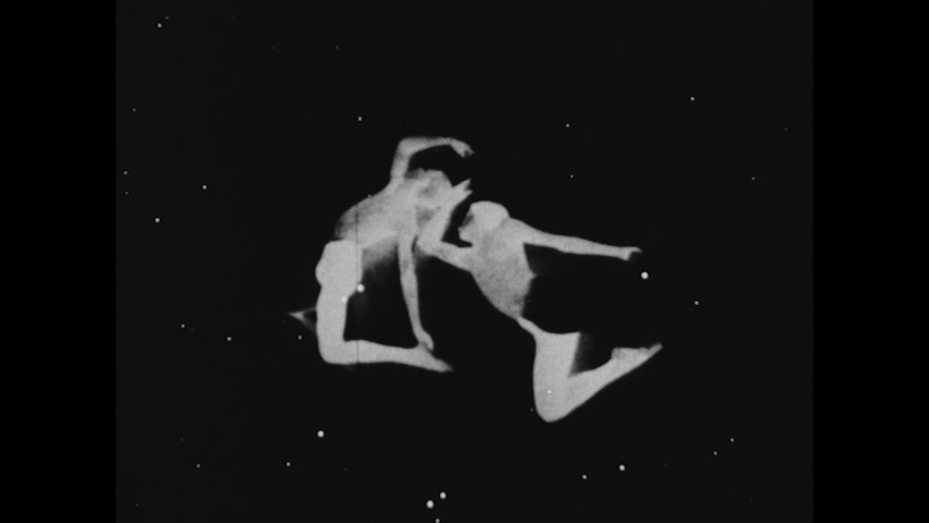 Two actors portraying Gemini in black and white tights which mirror each other