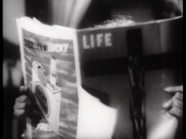Meena reads an issue of Life magazine with a Christ on the cover