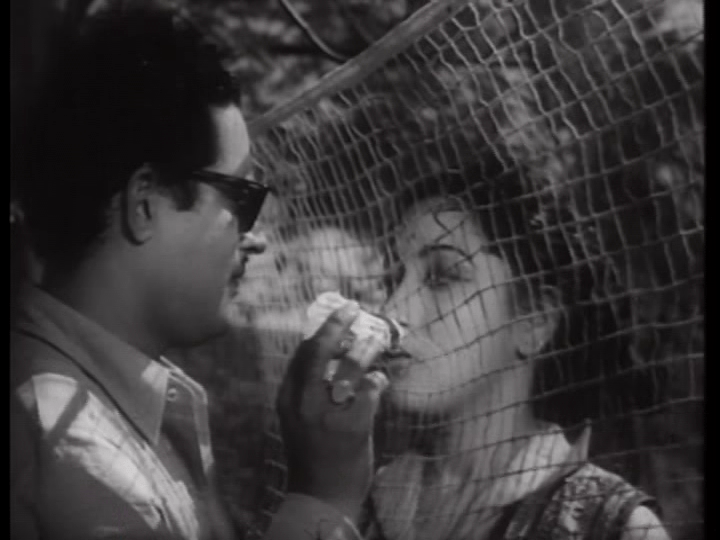 Vijay and Meena hold hands through a badminton net