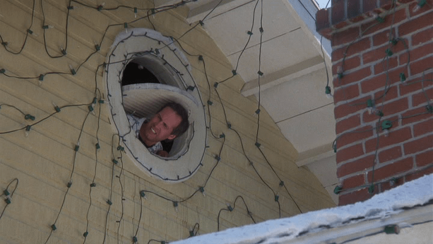 Clark Griswold sticks his head out of an attic window