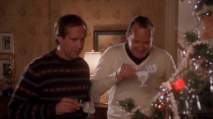 Clark and Cousin Eddie holding moose glasses