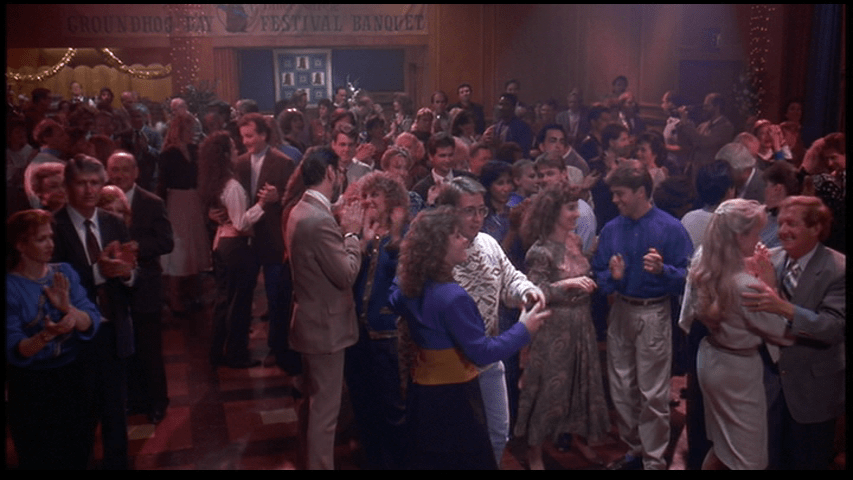 Phil talks to Rita in long shot