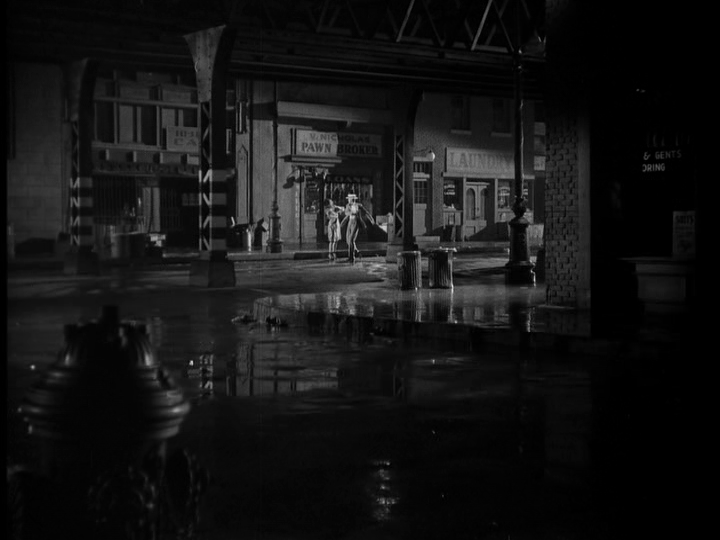 Long shot of a man hitting a woman