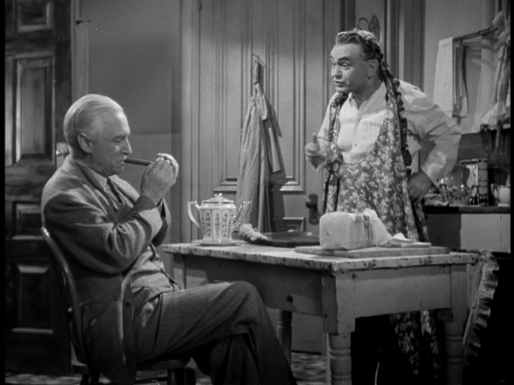 Chris dons a floral apron