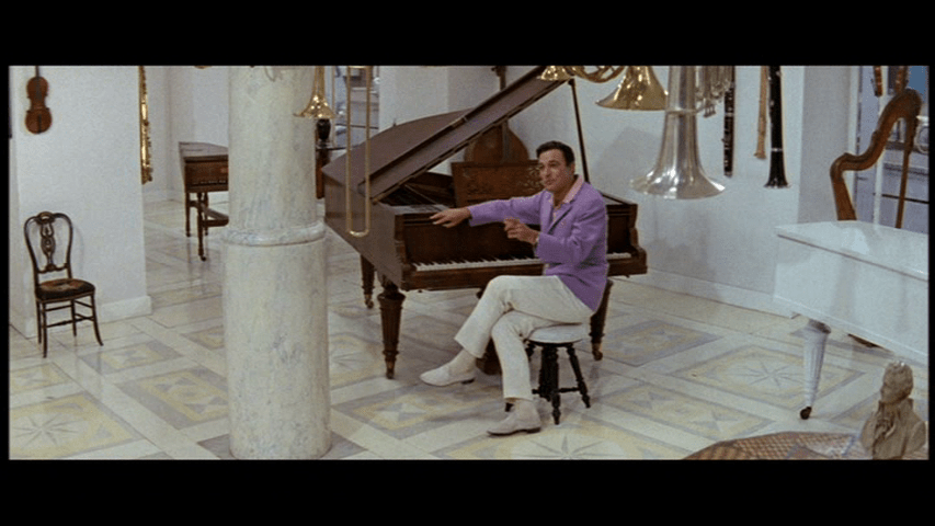 Andy Miller sitting at a piano in the lilac sports coat that Stephanie Zacharek likes