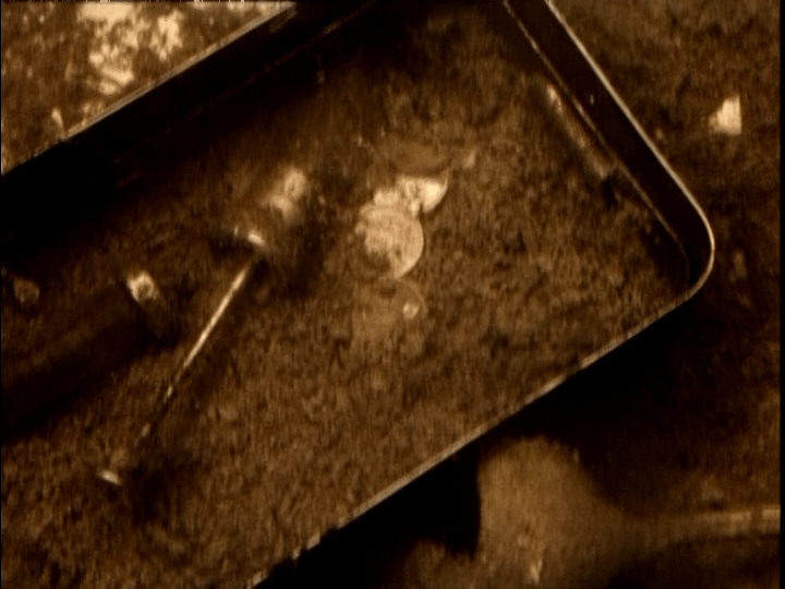 Close-up of submerged coins and syringes
