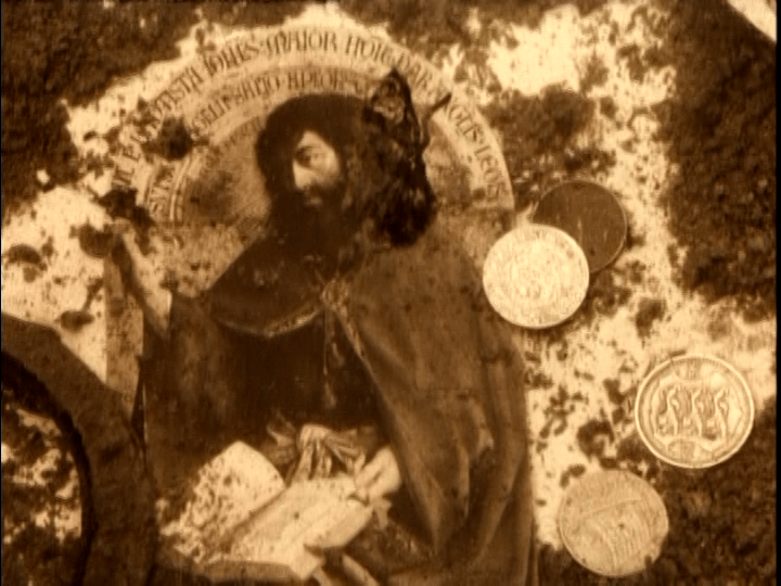 Close-up of submerged coins and a panel from the Ghent Altarpiece by Hubert and Jan van Eyck