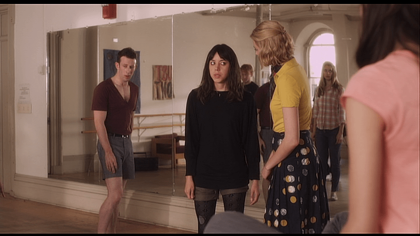 Depressed Debbie talks to Violet while Freak Astaire, Priss, and the other dancers wait for them to finish