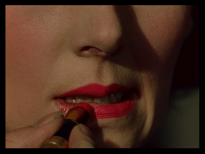 Close-up of Sister Ruth applying lipstick