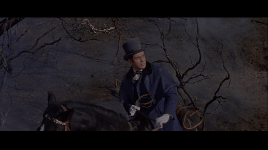 Medium shot of Philip Winthrop on a horse looking at something offscreen