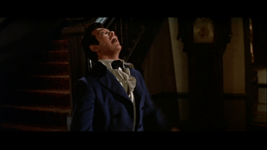 Philip looks up in horror at the chandelier about to fall on him