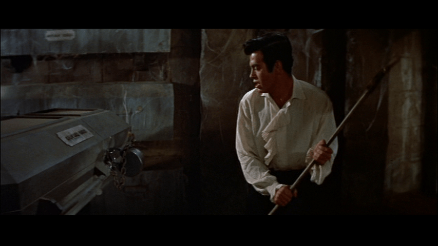 Philip breaks the lock on Madeline's casket with an axe