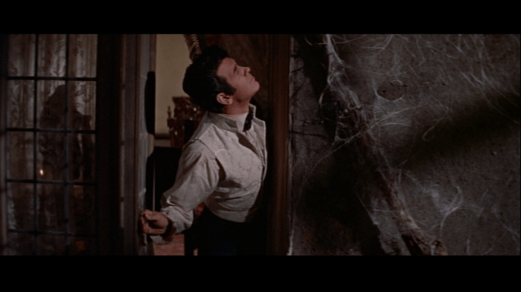 Medium shot of Philip craning his neck to look at something