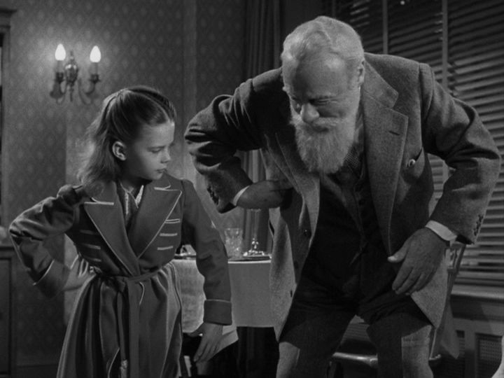 Medium shot of Kris showing Susan how to be a monkey, part two