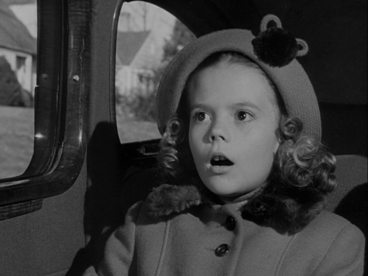 Close-up of Susan looking astonished by something she has seen out her window