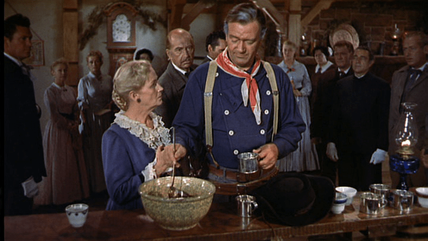 Ethan Edwards serves himself a glass of punch