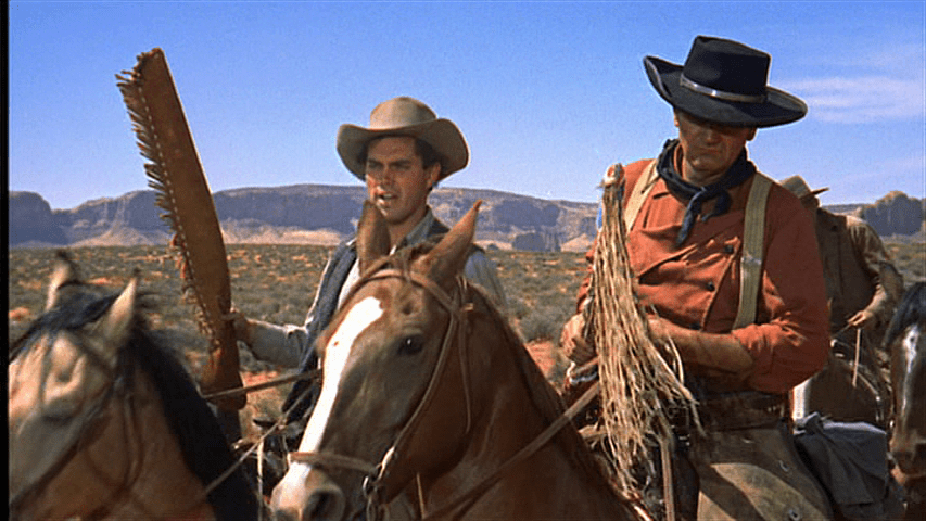 Medium shot of Marty and Ethan talking atop their horses