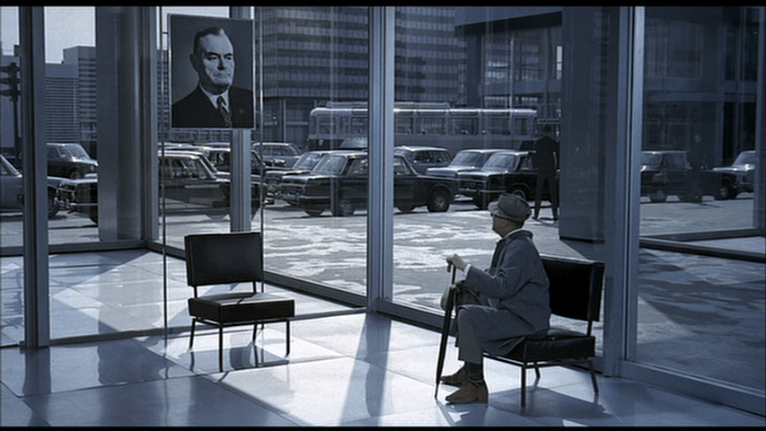 Hulot looks back at a portrait that seems to be eying him disapprovingly