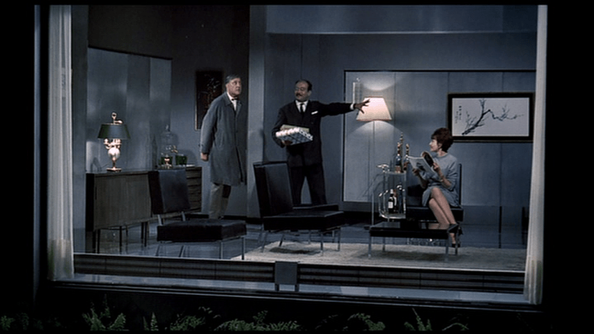 Schneider shows off his apartment, which looks like it's inside a picture frame, to Hulot