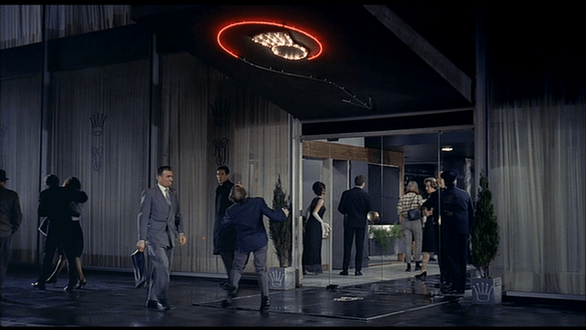 As a red neon arrow also appears, the drunk spins around in an effort to follow it