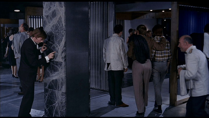 The map now lies on the floor, but the drunk continues trying to trace a route