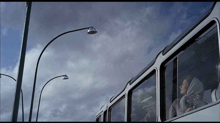 ...then out the window of her bus at the streetlights it's passing under, which have a similar appearance
